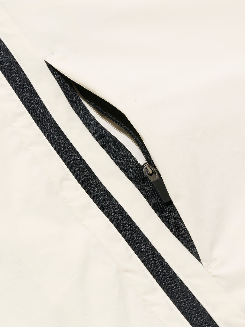 DRIVE Cream golf wind jacket: concealed zip pocket detail
